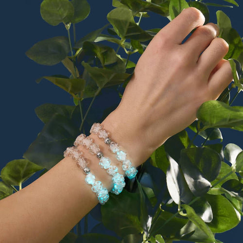 Ivory Silver Firefly Glass Clover Bracelets glowing on wrist with hand-blown glass beads and stainless steel accents by NOGU
